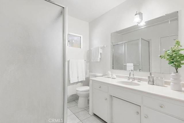 bathroom with toilet, vanity, tile patterned floors, and a shower with shower door