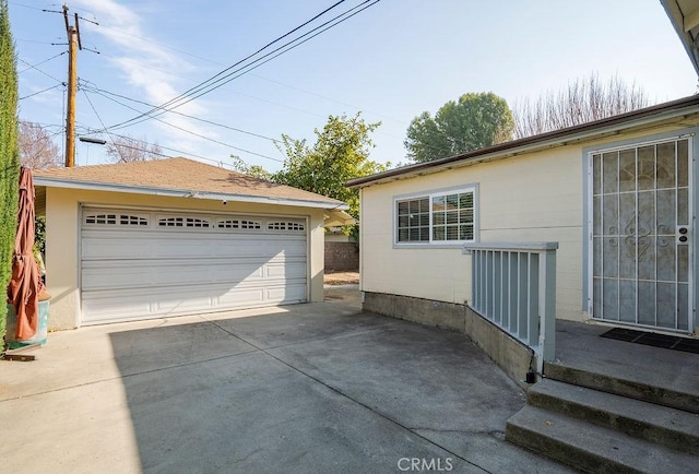 view of side of property featuring a garage and an outbuilding