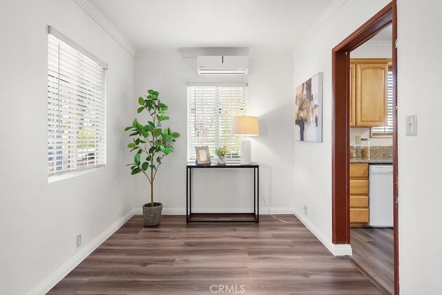 corridor with a wall unit AC, plenty of natural light, dark wood-type flooring, and ornamental molding