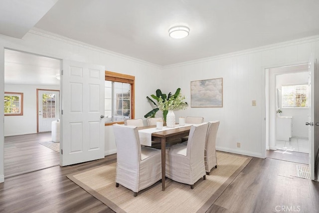 dining area featuring hardwood / wood-style floors and ornamental molding