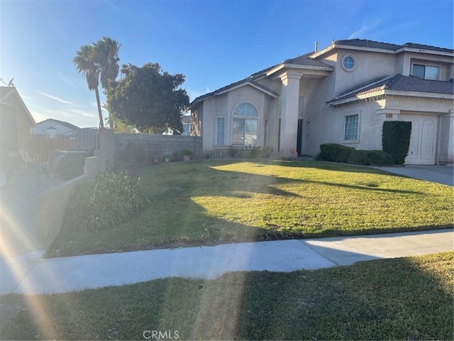 view of front of property with a garage and a front lawn