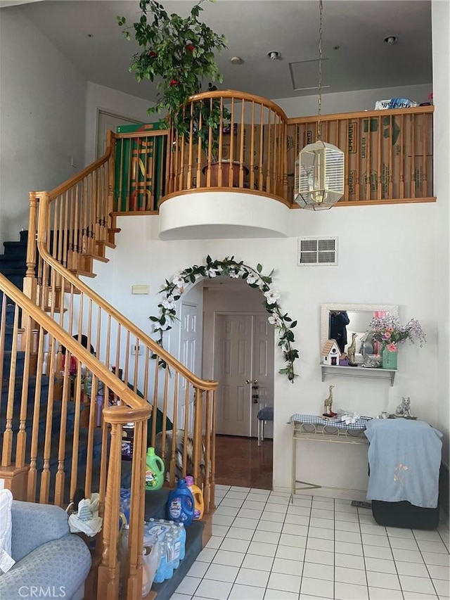 stairs featuring tile patterned flooring