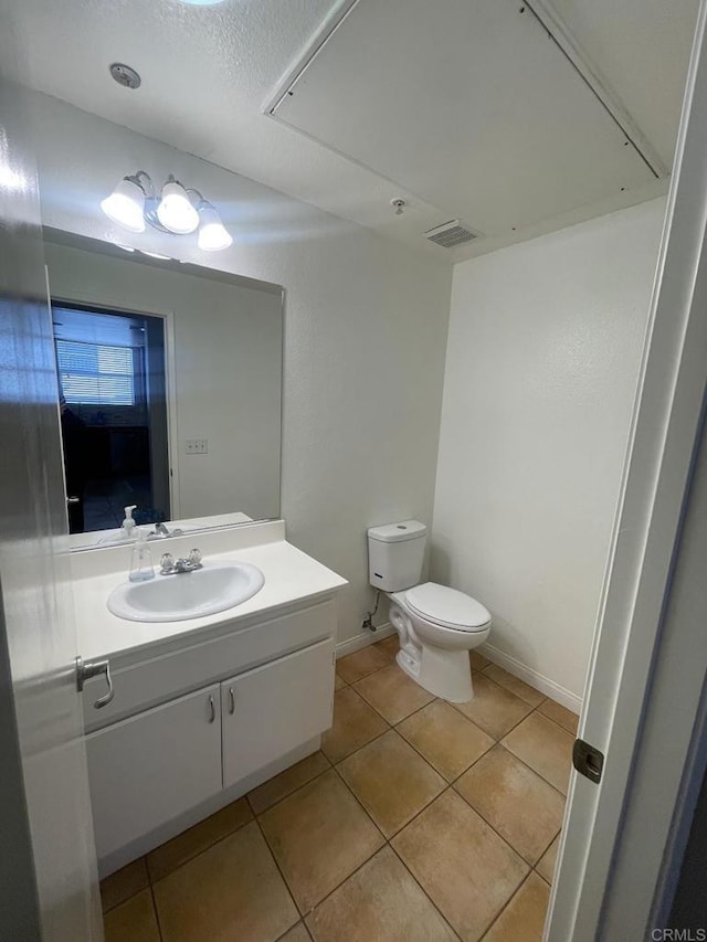 bathroom with tile patterned floors, vanity, and toilet