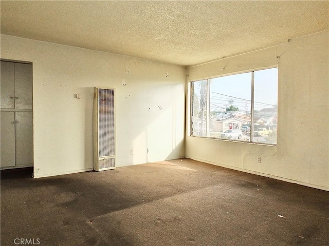 spare room with carpet floors and a textured ceiling