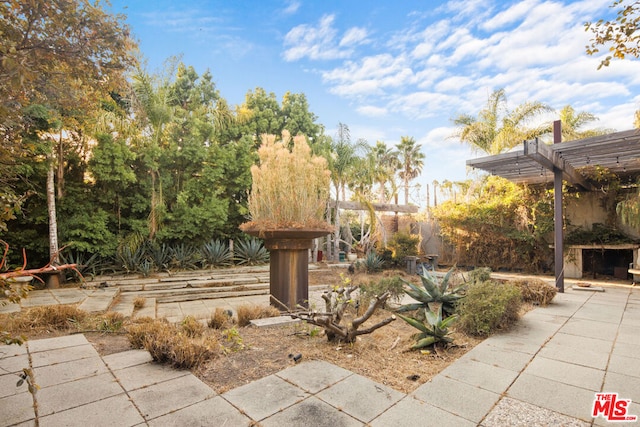 view of community featuring a pergola and a patio area