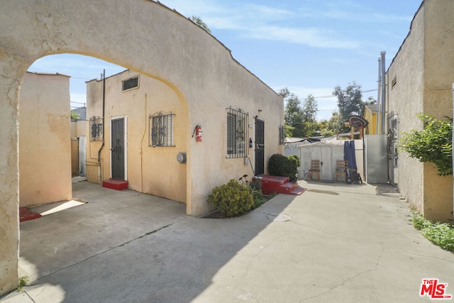 view of side of home with a patio area