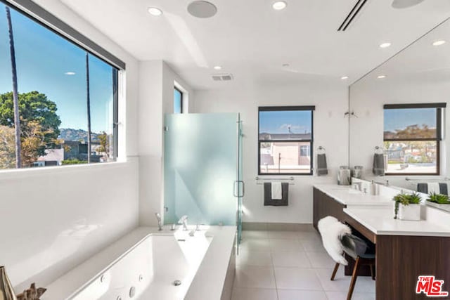 bathroom featuring tile patterned flooring, vanity, and separate shower and tub