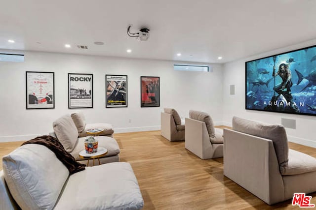 home theater room featuring light wood-type flooring