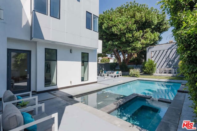 view of pool featuring an in ground hot tub and a patio