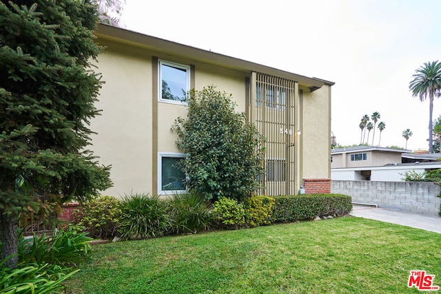 view of side of home featuring a lawn