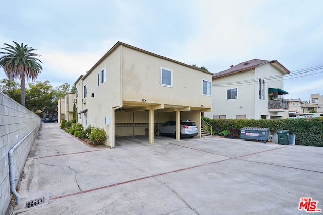 rear view of property featuring a carport