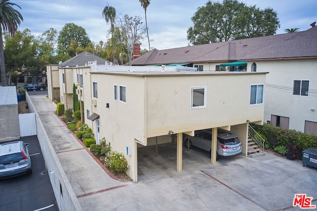 view of property exterior with a carport