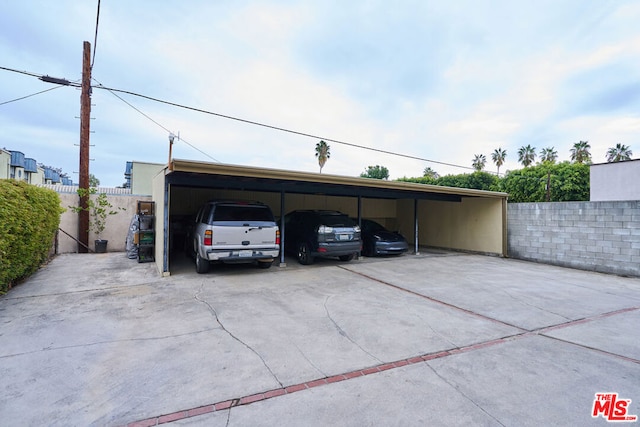 view of parking / parking lot featuring a carport