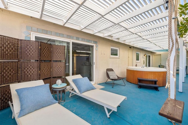 view of patio / terrace with a hot tub and a pergola