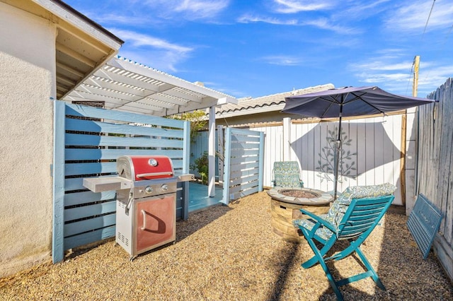 view of patio / terrace featuring grilling area, a pergola, and a fire pit