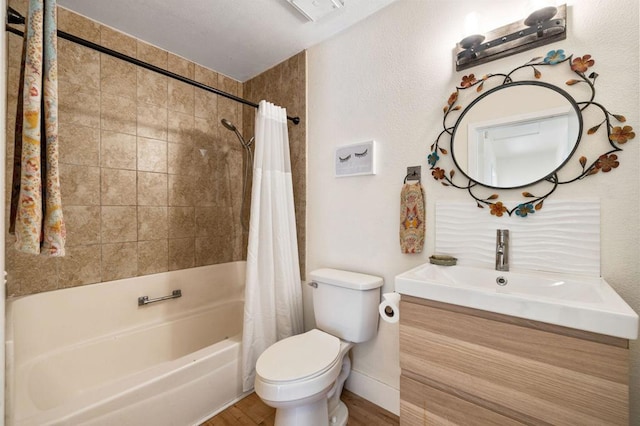 full bathroom featuring vanity, hardwood / wood-style floors, toilet, and shower / bath combo