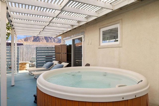 view of patio featuring a hot tub and a pergola