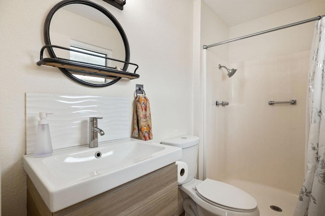 bathroom with walk in shower, vanity, and toilet