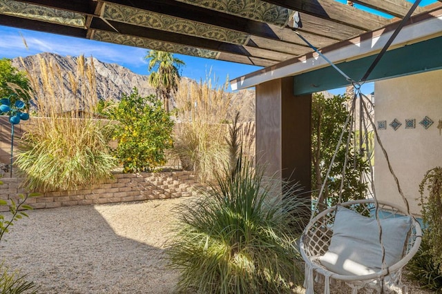 view of yard with a mountain view, a patio area, and a pergola