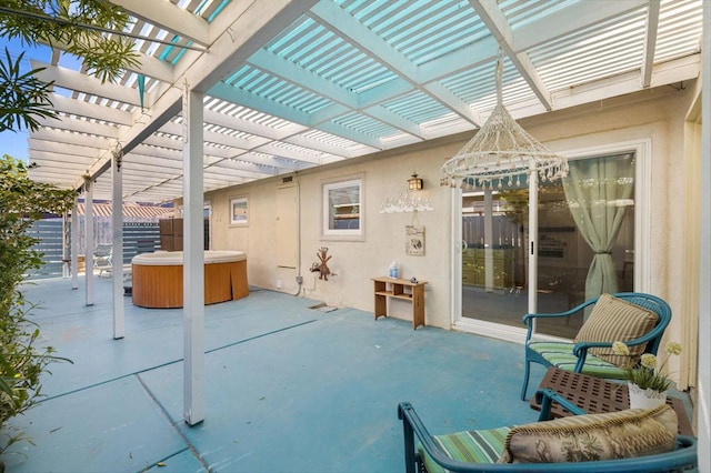 view of patio / terrace featuring a hot tub and a pergola