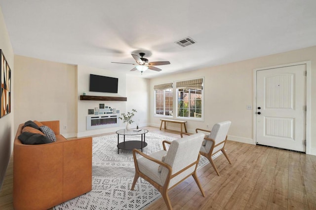 living room featuring ceiling fan and light wood-type flooring