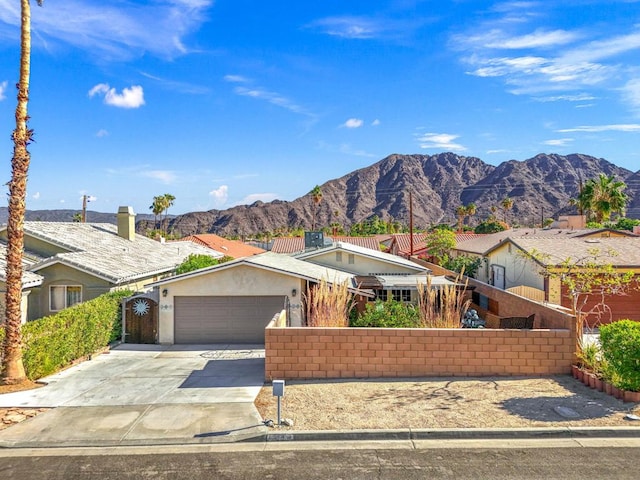 ranch-style home with a mountain view and a garage