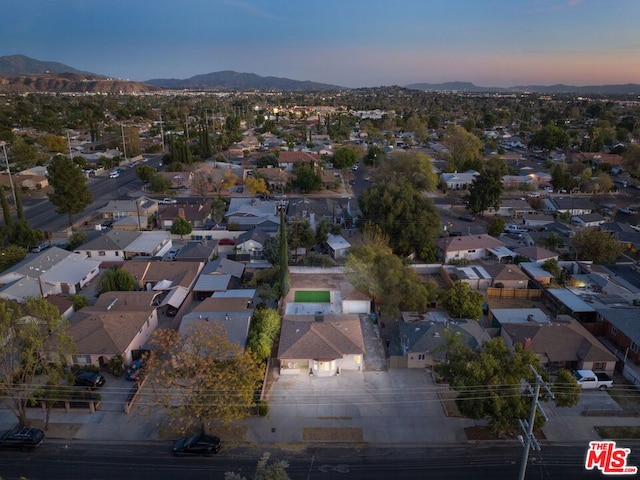 aerial view at dusk featuring a mountain view