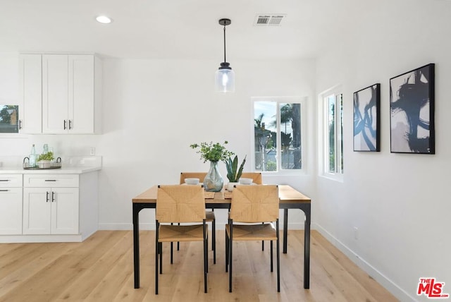 dining space with light wood-type flooring