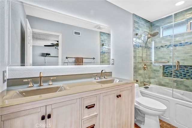 full bathroom with vanity, shower / bath combination with glass door, and toilet