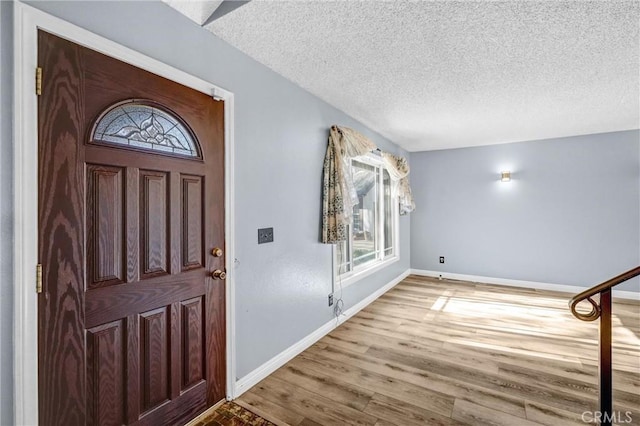 foyer featuring hardwood / wood-style floors and a textured ceiling