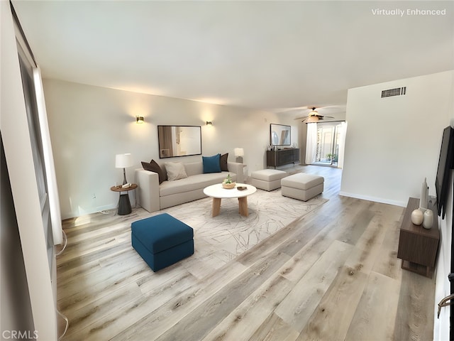 living room with ceiling fan and light wood-type flooring