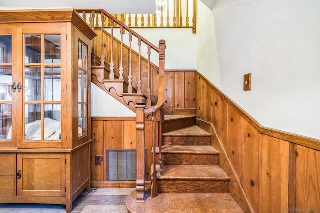 stairway with wood walls