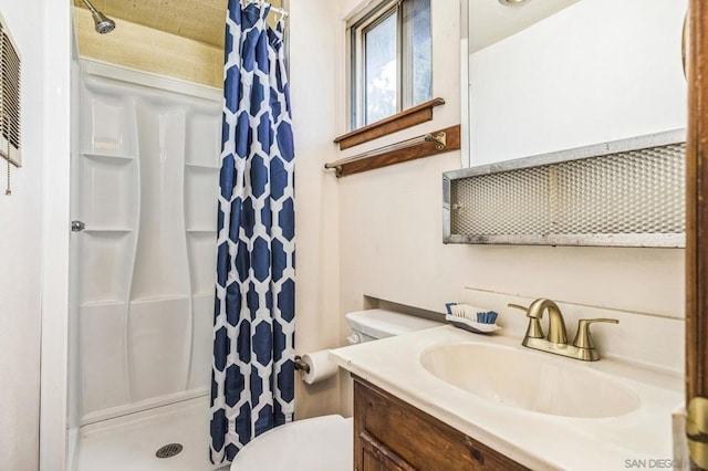 bathroom featuring toilet, vanity, and a shower with shower curtain