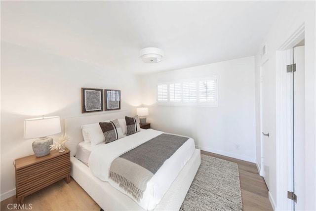 bedroom with hardwood / wood-style flooring