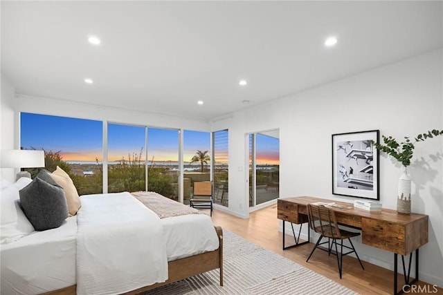 bedroom featuring light wood-type flooring and access to exterior