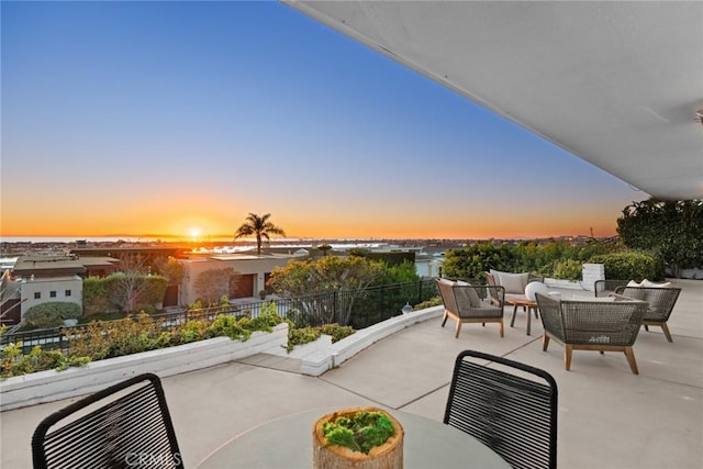 patio terrace at dusk featuring an outdoor hangout area