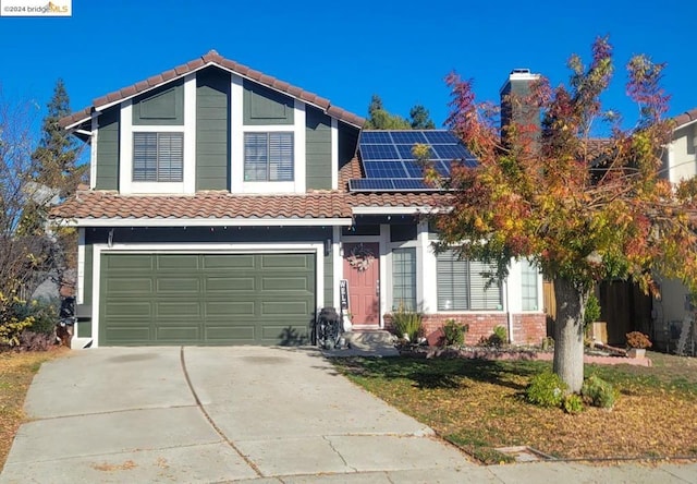 view of front of house with solar panels and a garage