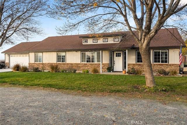 view of front of home with a front yard and a garage