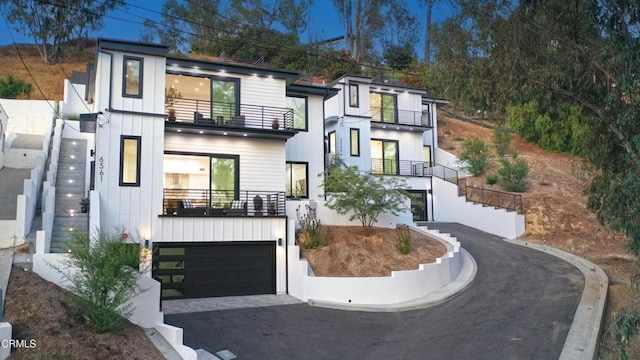 contemporary home with a garage and a balcony