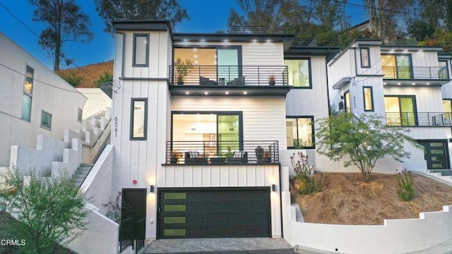 modern home with a balcony and a garage