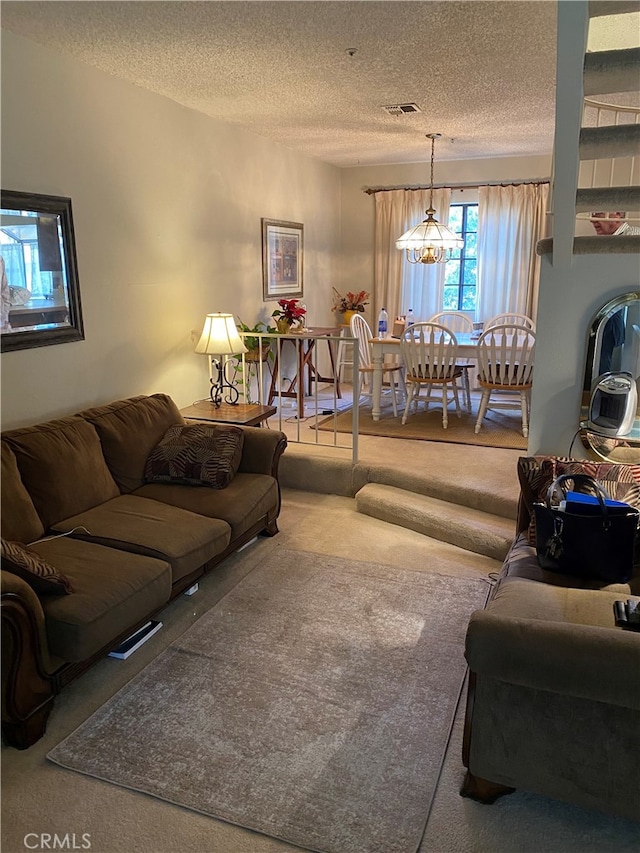 living room with carpet floors and a textured ceiling