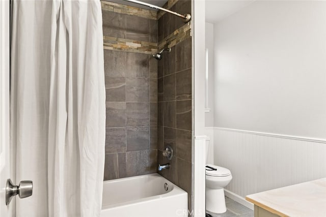 full bathroom featuring tile patterned flooring, vanity, toilet, and shower / bath combo with shower curtain