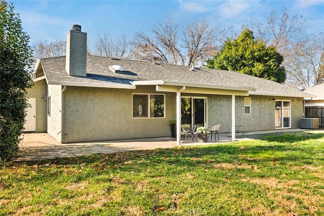 rear view of property with a patio area, a yard, and central AC unit