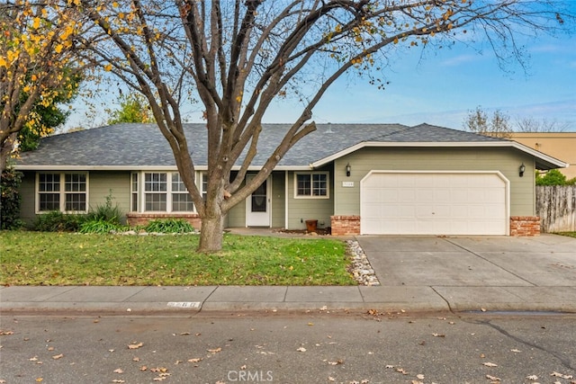 ranch-style house with a front yard and a garage