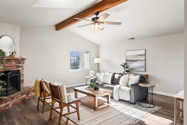 living room featuring hardwood / wood-style floors, lofted ceiling with beams, ceiling fan, and a brick fireplace