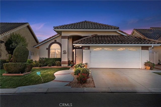 mediterranean / spanish-style house with a garage