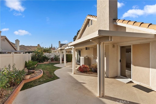 view of patio / terrace with a fenced backyard and central AC