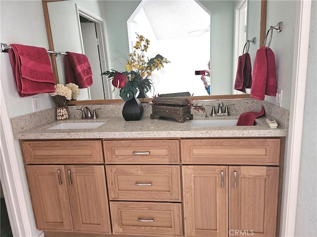 full bathroom featuring a ceiling fan, a sink, and double vanity