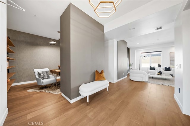 hallway with light hardwood / wood-style floors