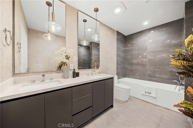 bathroom with tile patterned floors, a washtub, vanity, and toilet